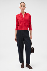 Profile view of model wearing the Oroton Collar Cardigan in Market Red and 100% super soft merino wool fabric for Women .