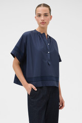 Profile view of model wearing the Oroton Trim Detail Smock in North Sea and 100% cotton fabric for Women .