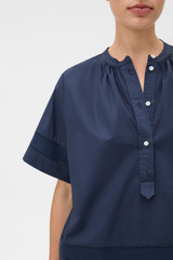 Profile view of model wearing the Oroton Trim Detail Smock in North Sea and 100% cotton fabric for Women .