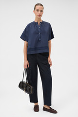 Profile view of model wearing the Oroton Trim Detail Smock in North Sea and 100% cotton fabric for Women .