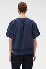 Profile view of model wearing the Oroton Trim Detail Smock in North Sea and 100% cotton fabric for Women .