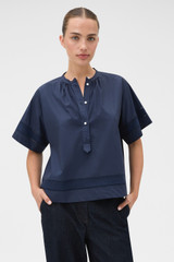 Profile view of model wearing the Oroton Trim Detail Smock in North Sea and 100% cotton fabric for Women .