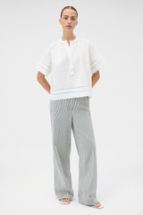 Profile view of model wearing the Oroton Railroad Folk Straight Leg Pant in North Sea and 96% cotton and 4% spandex blend fabric for Women .