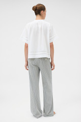 Profile view of model wearing the Oroton Railroad Folk Straight Leg Pant in North Sea and 96% cotton and 4% spandex blend fabric for Women .