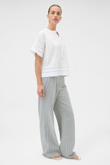 Profile view of model wearing the Oroton Railroad Folk Straight Leg Pant in North Sea and 96% cotton and 4% spandex blend fabric for Women .