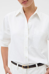 Profile view of model wearing the Oroton Oxford Cropped Shirt in Antique White and 100% cotton fabric for Women .