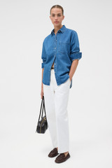 Profile view of model wearing the Oroton Denim Shirt in Denim and 100% cotton fabric for Women .
