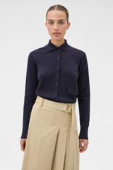 Profile view of model wearing the Oroton Collar Cardigan in North Sea and 100% super soft merino wool fabric for Women .