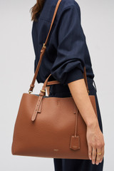 Profile view of model wearing the Oroton Margot Large Day Bag in Whiskey and Pebble leather for Women .