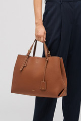 Profile view of model wearing the Oroton Margot Large Day Bag in Whiskey and Pebble leather for Women .