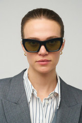 Profile view of model wearing the Oroton Sebes Sunglasses in Black and Acetate material for Women .