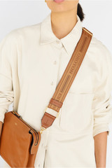 Profile view of model wearing the Oroton Heather Long Light Gold Webbing Strap in Tan/Cognac and 100% polyester material for Women .