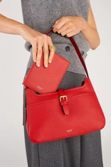 Profile view of model wearing the Oroton Dylan Baguette in Dark Ruby and Premium pebble leather for Women .