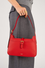Profile view of model wearing the Oroton Dylan Baguette in Dark Ruby and Premium pebble leather for Women .