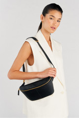 Profile view of model wearing the Oroton Lilly Belt Bag in Black and Premium smooth leather for Women .