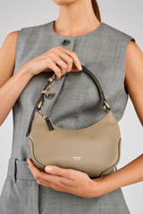 Profile view of model wearing the Oroton Zoey Small Hobo in Mushroom and Pebble leather for Women .
