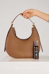 Profile view of model wearing the Oroton Dylan Hobo in Tan and Premium pebble leather for Women .