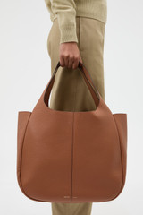 Profile view of model wearing the Oroton Emilia Large Tote in Brandy and  for Women .