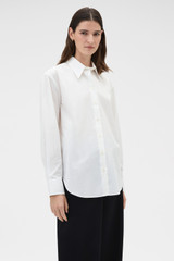 Profile view of model wearing the Oroton Wren Poplin Shirt in Antique White and 100% cotton fabric for Women .