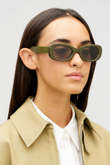 Profile view of model wearing the Oroton Rumi Bio Acetate Sunglasses in Khaki and Acetate for Women .