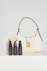 Profile view of model wearing the Oroton Yvonne Baguette in Cream and Premium pebble leather for Women .
