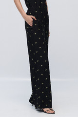 Profile view of model wearing the Oroton Mini Daisy Jacquard Pyjama Pants in Black and Made with 84% viscose and 16% polyester for Women .