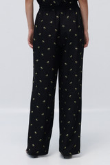 Profile view of model wearing the Oroton Mini Daisy Jacquard Pyjama Pants in Black and Made with 84% viscose and 16% polyester for Women .