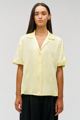 Profile view of model wearing the Oroton Embroidered Leaf Short Sleeve Camp Shirt in Lemon and 100% viscose fabric for Women .