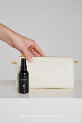 Profile view of model wearing the Oroton Harvey Baguette Crossbody in Cream and Premium smooth leather for Women .