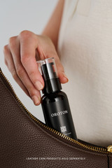 Profile view of model wearing the Oroton Dorit Hobo Bag in COFFEE BEAN and Premium pebble leather for Women .