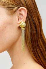 Profile view of model wearing the Oroton Naia Tassel Earrings in Worn Gold and Brass material for Women . IP:2