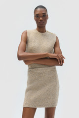 Profile view of model wearing the Oroton Nep Knit Mini Skirt in Oat and 65% merino wool, 30% nylon, and 5% alpaca blend fabric for Women .