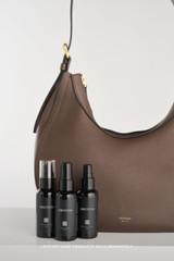 Profile view of model wearing the Oroton Dylan Hobo in COFFEE BEAN and Premium pebble leather for Women .