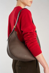 Profile view of model wearing the Oroton Dylan Hobo in COFFEE BEAN and Premium pebble leather for Women .