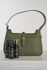 Profile view of model wearing the Oroton Dylan Baguette in CACTUS and Premium embossed leather for Women .