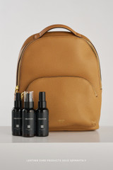 Profile view of model wearing the Oroton Dylan Small Backpack in Tan and Pebble leather for Women .
