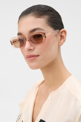Profile view of model wearing the Oroton Rumi Sunglasses in Rose and Acetate material for Women .