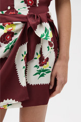 Profile view of model wearing the Oroton Folk Doilie Sarong Skirt in Burgundy and 100% silk fabric for Women .