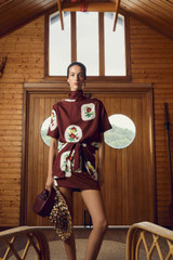 Profile view of model wearing the Oroton Folk Doilie Sarong Skirt in Burgundy and 100% silk fabric for Women .
