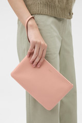 Profile view of model wearing the Oroton Eve Medium Pouch in BLOSSOM and Premium pebble leather for Women .