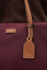 Profile view of model wearing the Oroton Lilly Nylon Light Weight Tote Bag in BURGUNDY and Nylon fabric for Women .