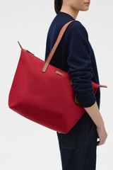 Profile view of model wearing the Oroton Lilly Nylon Light Weight Tote Bag in DARK RUBY and Nylon fabric for Women .