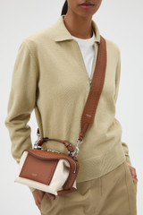 Profile view of model wearing the Oroton Mica Broguing Bag Strap in PENNY BROWN and Premium smooth leather for Women .