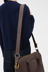 Profile view of model wearing the Oroton Heather Long Light Gold Webbing Strap in COFFEE BEAN and 100% polyester material for Women .