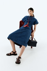 Profile view of model wearing the Oroton Denim Dress in Denim and 100% cotton fabric for Women .