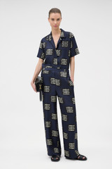 Profile view of model wearing the Oroton Marine Fish Pyjama Pant in NORTH SEA and 100% lightweight fluid silk twill fabric with a fine weave for Women .