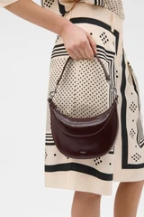Profile view of model wearing the Oroton Florence Small Shoulder Bag in COPPER and Premium crackle leather for Women .