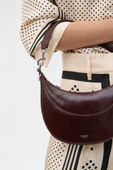 Profile view of model wearing the Oroton Florence Small Shoulder Bag in COPPER and Premium crackle leather for Women .