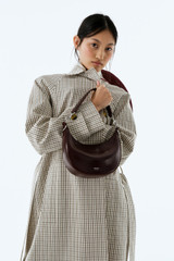 Profile view of model wearing the Oroton Florence Small Shoulder Bag in COPPER and Premium crackle leather for Women .