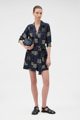 Profile view of model wearing the Oroton Marine Fish Tunic Dress in NORTH SEA and 100% lightweight, fluid silk twill fabric with a fine weave for Women .